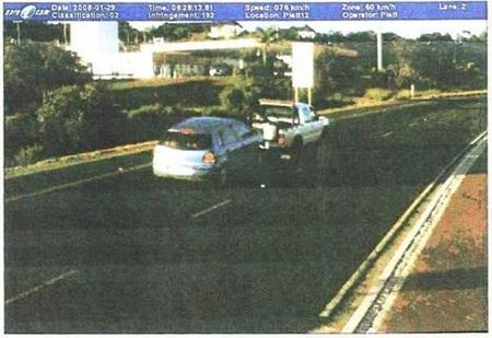 Photograph of a tow-truck
towing a car down a road.